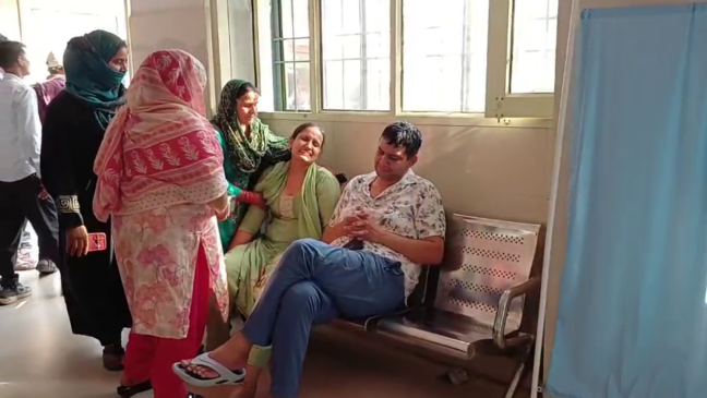 Four people including two women and an infant